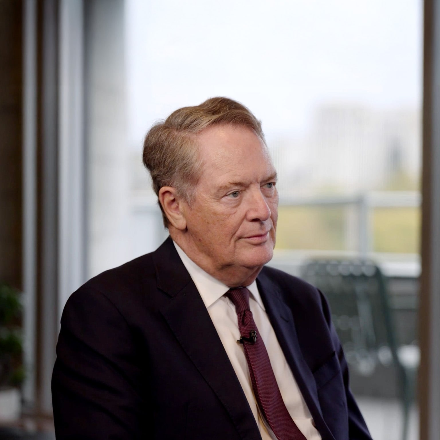 Robert Lighthizer in a suit and tie, seated and looking slightly to his right with a composed, attentive expression.