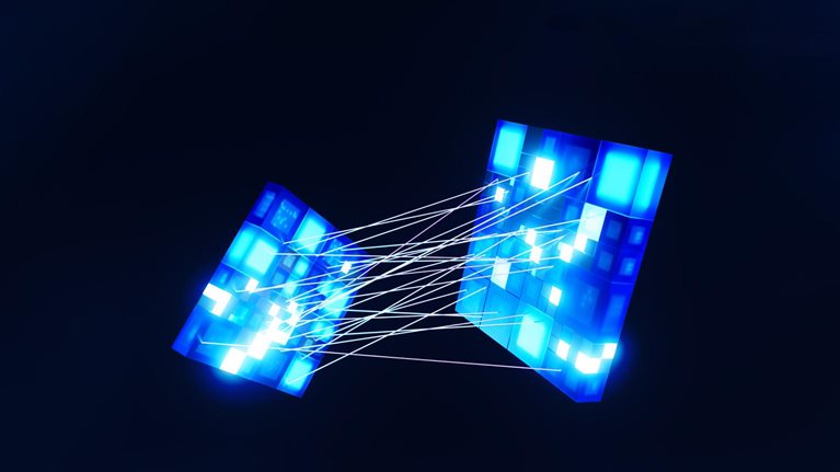 Two bright blue cubes, made up of smaller blue squares with digital patterns. Delicate white lines connect the cubes, giving the impression that they are being drawn together.