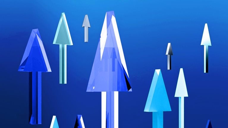 A collection of vertically-oriented arrows in different tones of blue and gray set against a blue backdrop. The arrows give the impression of being crafted from glass or crystal and have a three-dimensional appearance.