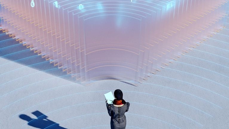 A woman holding a tablet gazes at a large, luminous structure made up of see-through panels and illuminated with blue binary code.