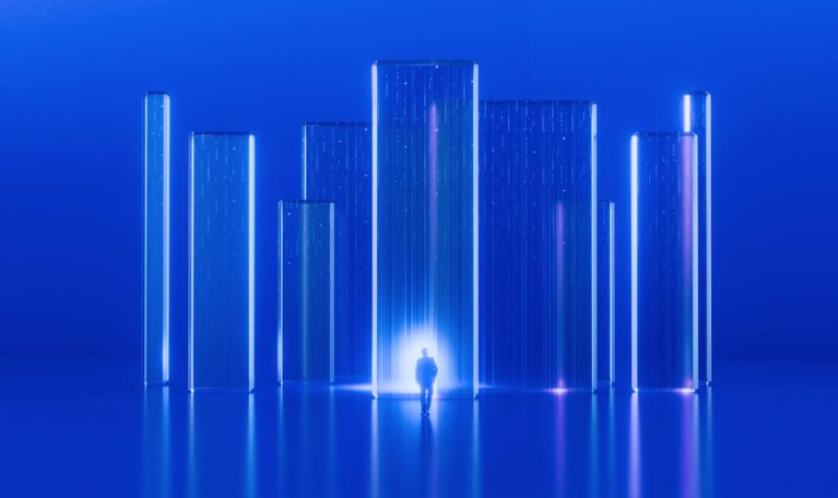 The image depicts a minimalist, futuristic digital artwork rendered in vibrant blue tones. A small silhouette of a person walking toward a bright, glowing light source. Several tall, transparent glass or crystal rectangular pillars resembling a abstract city skyline. Glowing vertical streaks and neon highlights in shades of blue and soft pink light up the structures. A perfectly smooth, glossy floor that mirrors the pillars and light, creating a symmetrical look.