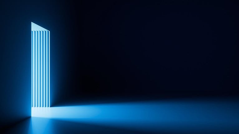 Bright light going through the door portal inside the empty dark room