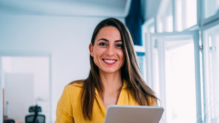 smiling woman holding tablet