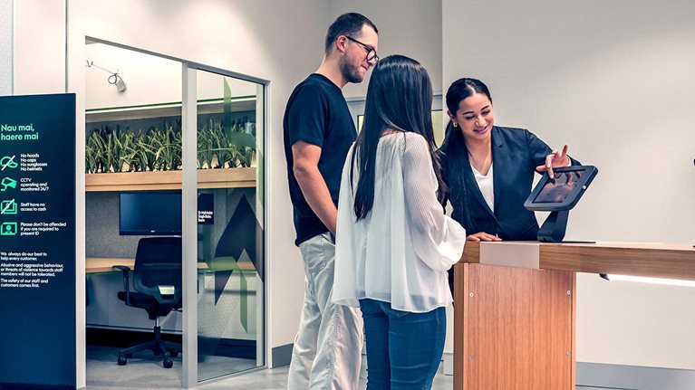 Kiwibank staff helping customers using a tablet
