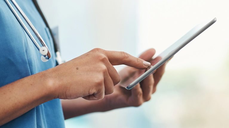 Closeup of female doctor with technology for innovation, communication or telehealth app search.