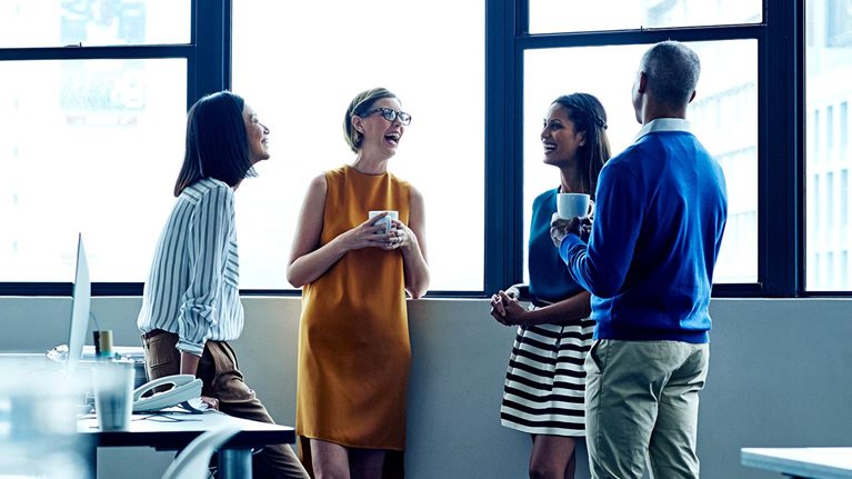 Four employees having a casual chat in office