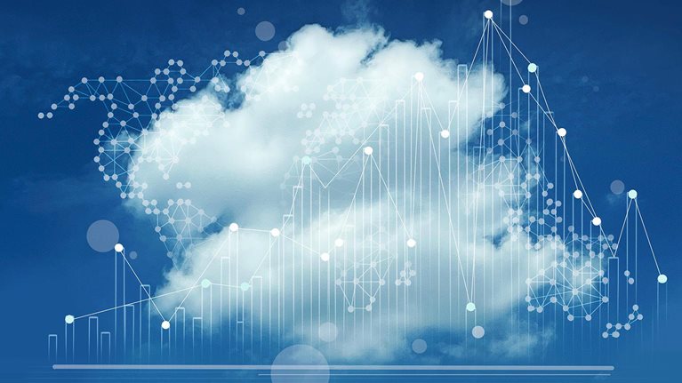One big cloud with line charts overlay against a dark blue background. - stock photo