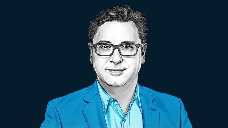 A hand-drawn illustration of Paul Hudson, smiling and wearing a button-down shirt and blazer. The drawing features precise lines and subtle shading, using black and white tones for her face and blues for her attire.