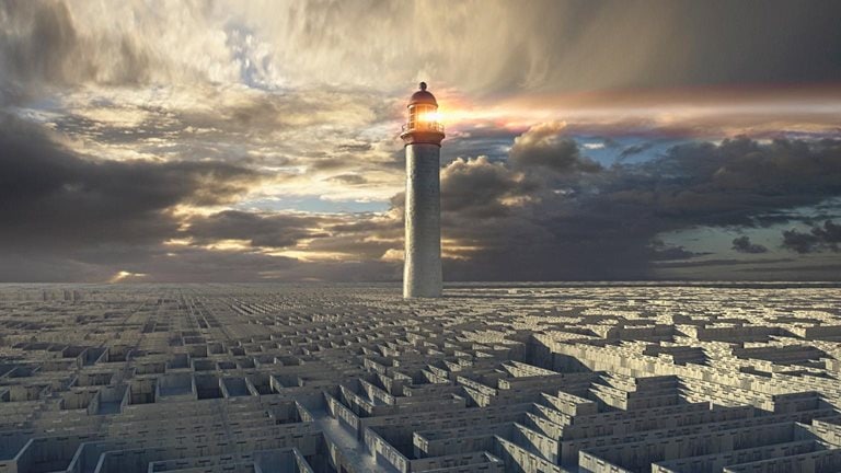 Lighthouse beaming above distant maze - stock photo