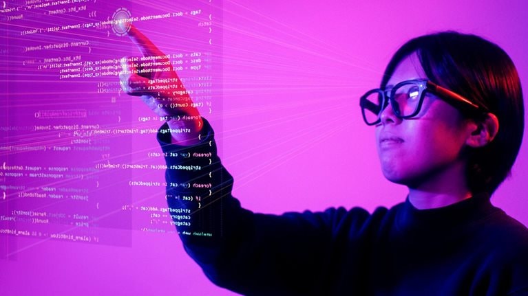 Young woman using virtual futuristic interface with smart glasses