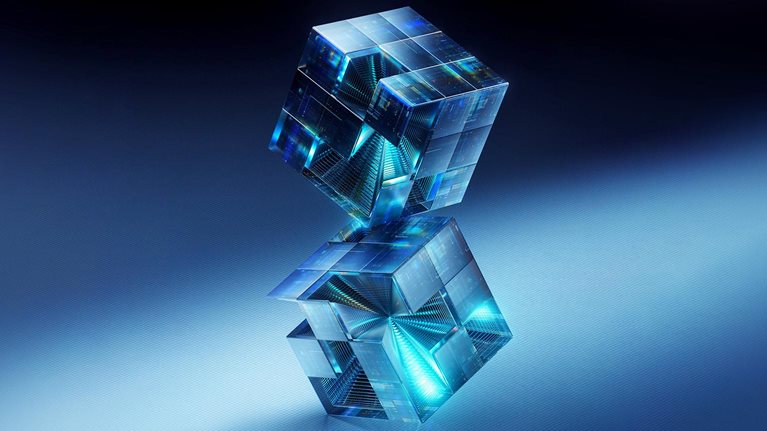 Image of two 3D translucent cubes with intricate internal structures and glowing blue light floating against a dark blue background.