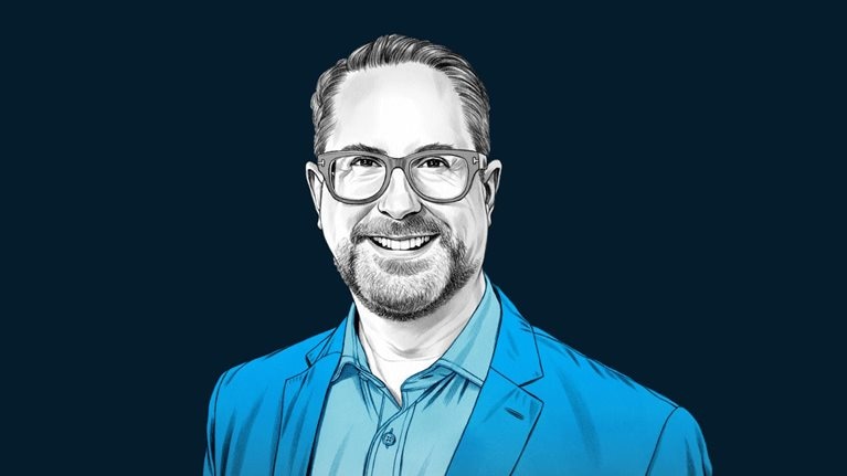 A hand-drawn illustration of Mark Boggett, with a friendly smile and wearing glasses, suit jacket and collared shirt. The drawing features precise lines and subtle shading, using black and white tones for his face and blues for his attire.