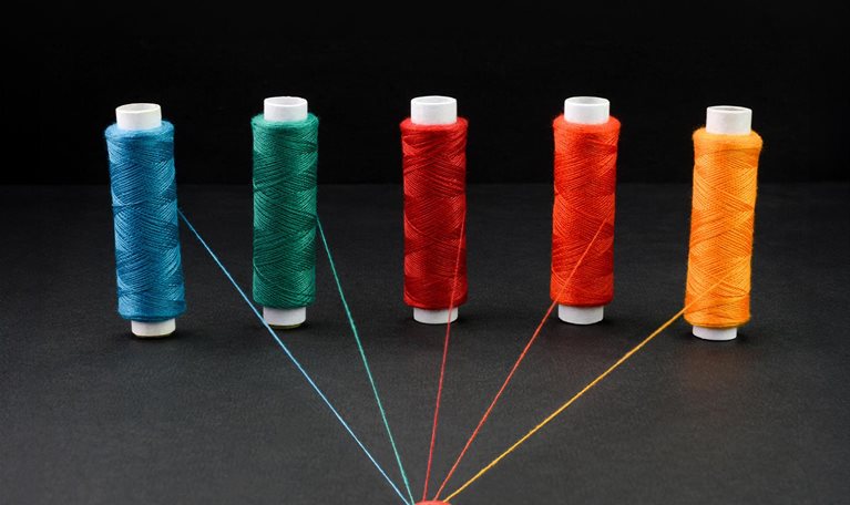 Multicolored spools of strings attached together, - stock photo