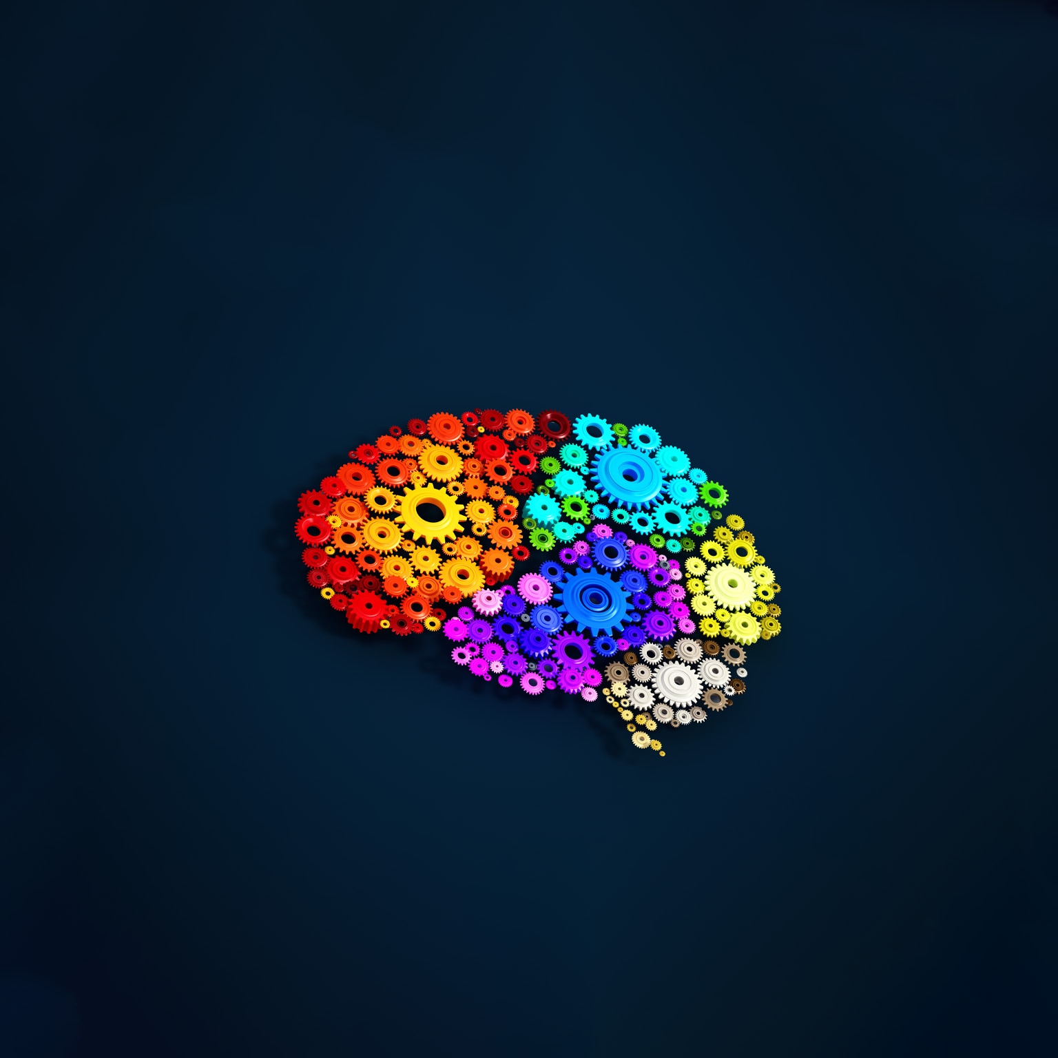 Colorful gears forming the shape of a brain on a dark blue background.