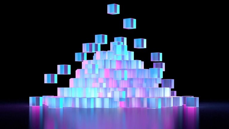 Numerous translucent cubes in shades of blue and pink, stacked a pyramid formation against a black background. The cubes appear to be glowing, creating a vibrant and futuristic aesthetic.