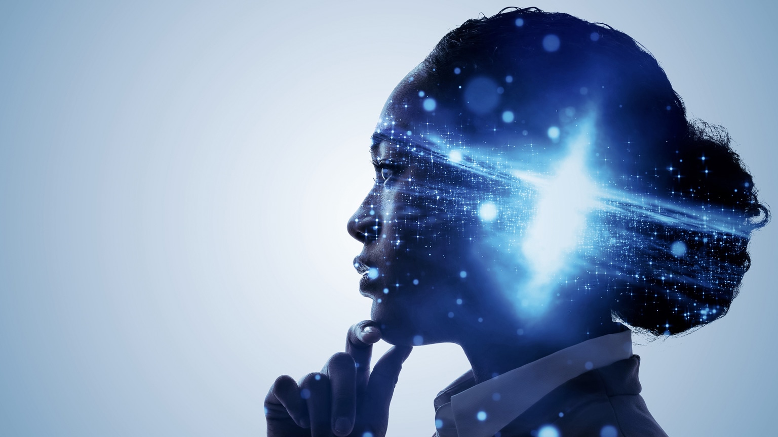 A profile of a woman with her hand up to her chin in a thoughtful pose.  A galaxy bursting with light is superimposed over profile, centered over her mind.