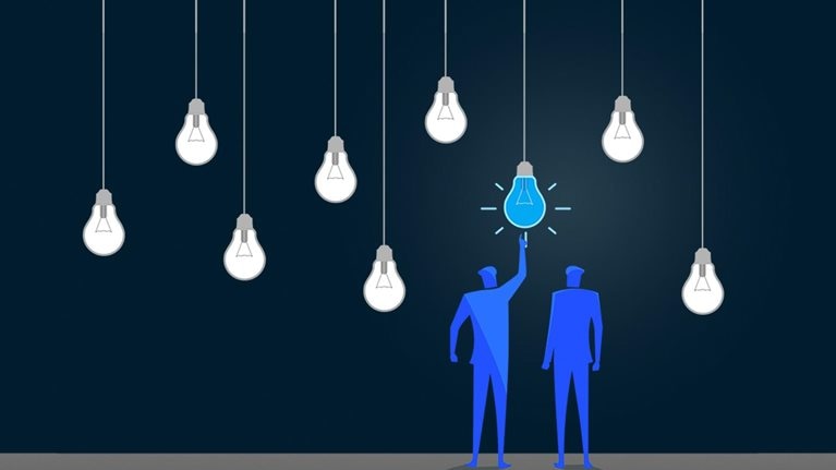 Standing out from the crowd. Two figures point to one red lightbulb in a series of hanging white lightbulbs. - stock illustration