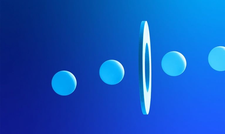 Line of balls going through a hole on floating white disc