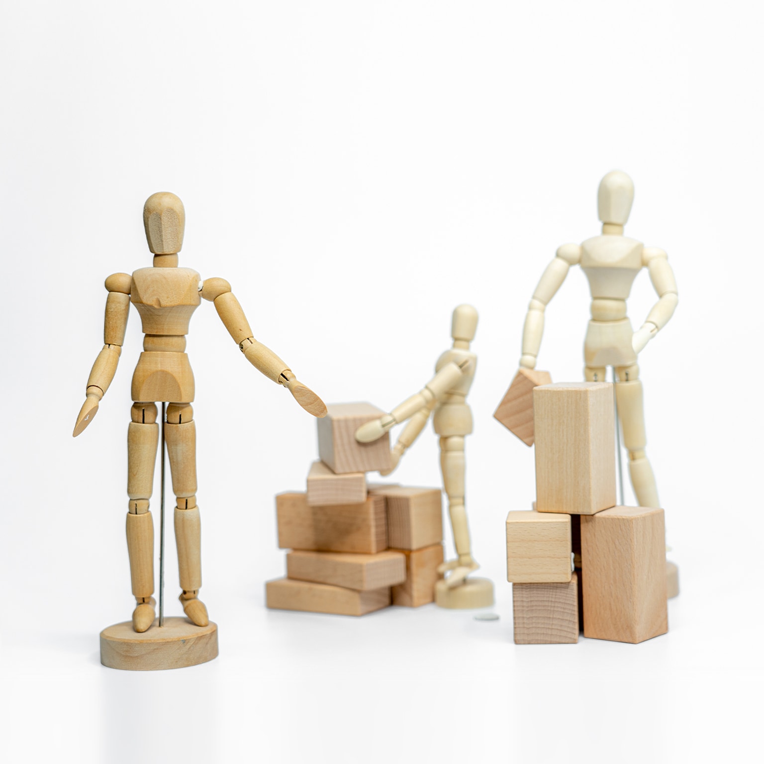 Wooden doll with wooden toy block isolated on white background. business or creative concept - stock photo