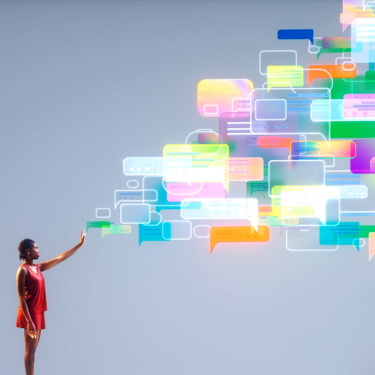 A person reaches into a cascade of colorful message bubbles, symbolizing agentic AI orchestrating empathetic, human-centered customer conversations at scale.