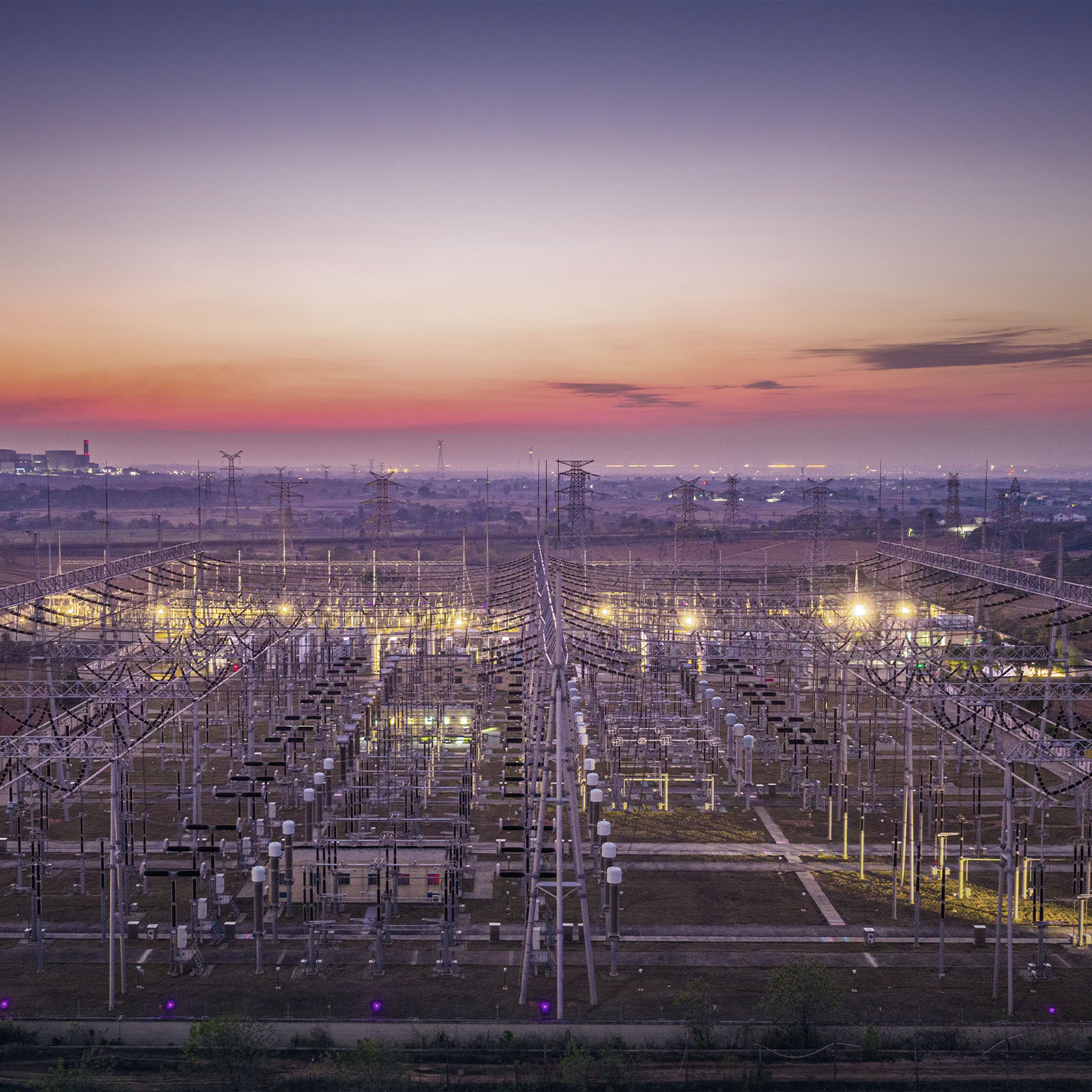 Big city, transmission towers at sunset