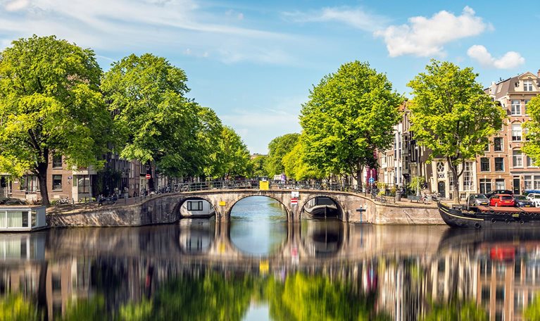 Reflection of bridge in Amsterdam on a summer day - stock photo