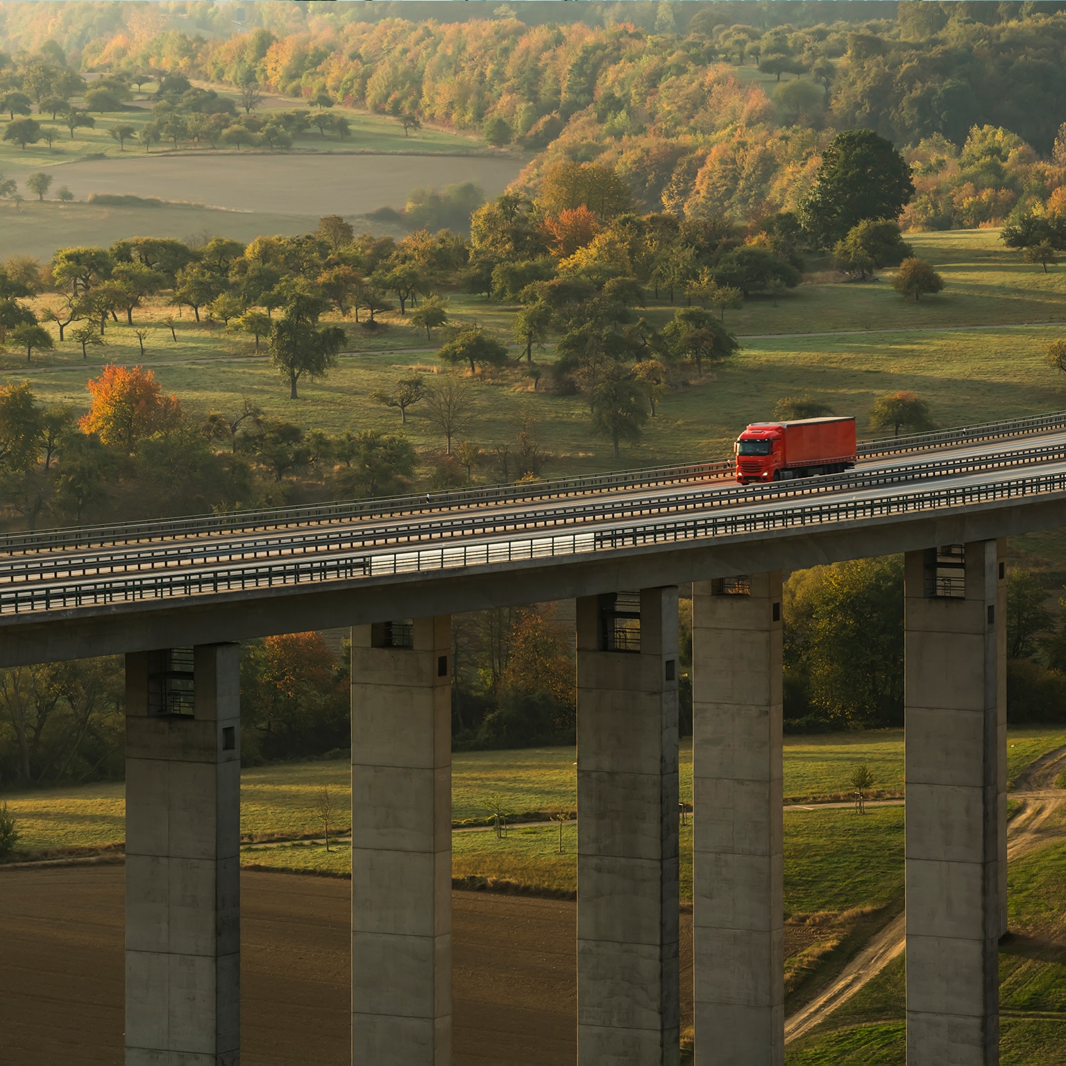 Truck on Autobahn bridge (dawn) - stock photo