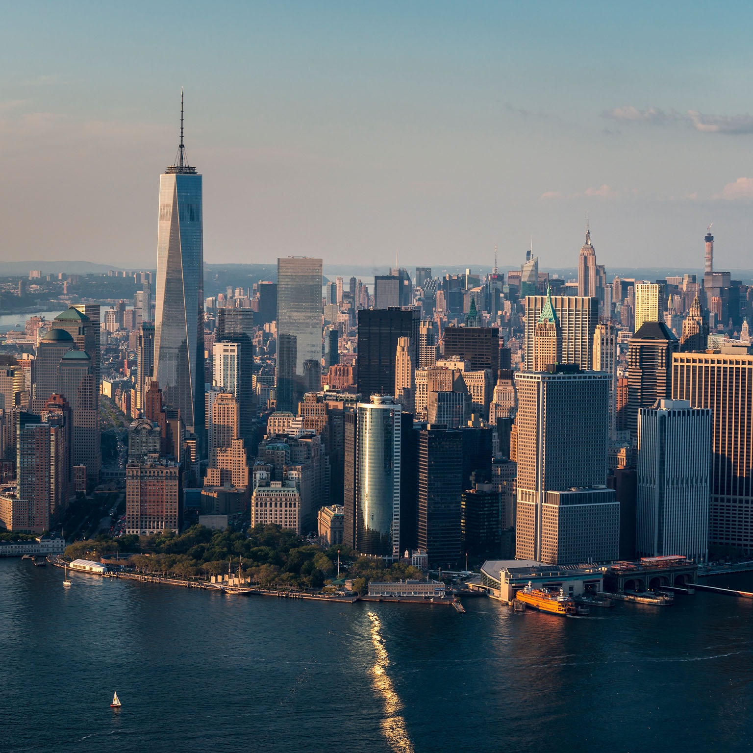 Aerial looking north of downtown Manhattan the World Trade center in the day flying over the East River and Hudson, in NYC