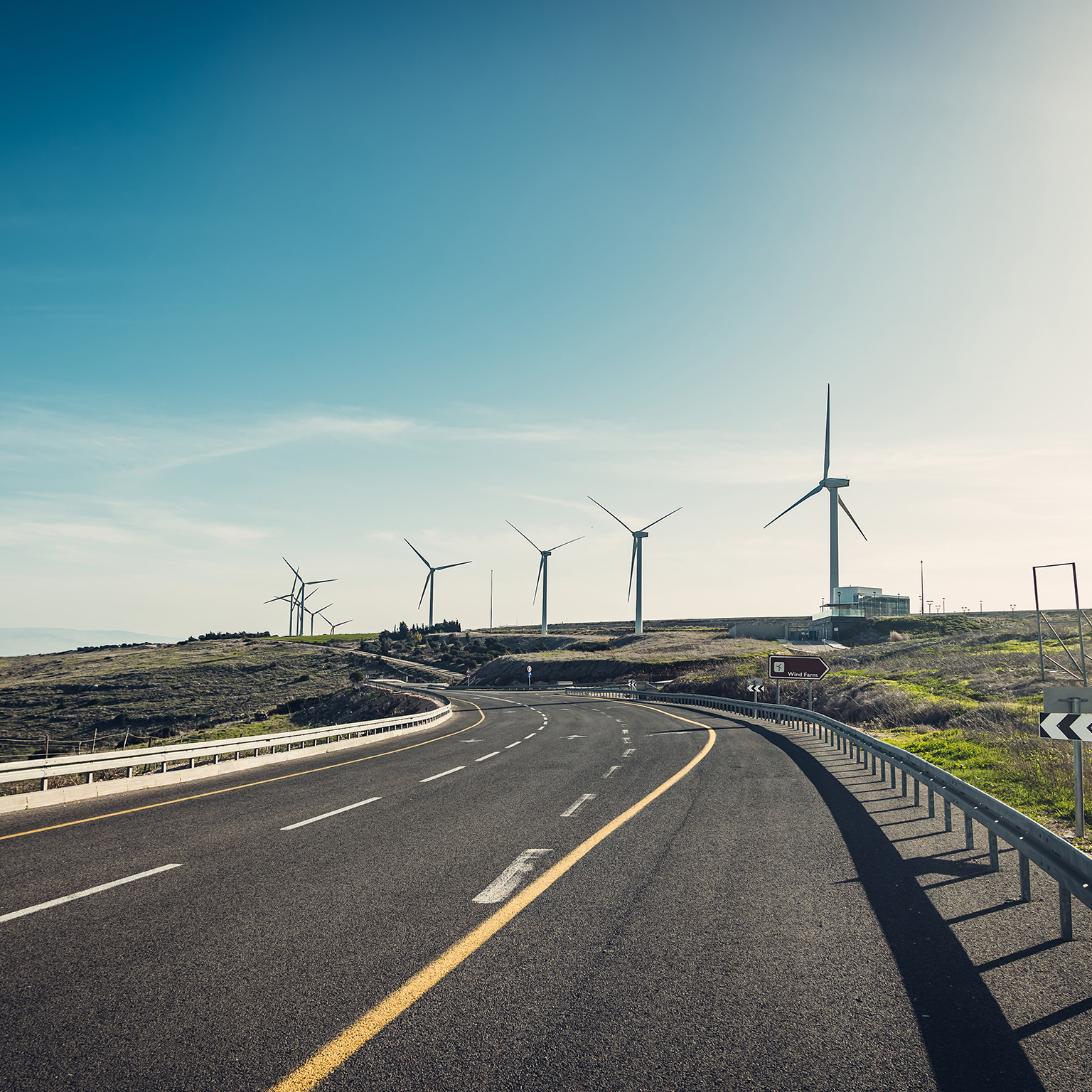 Asphalt highway with Wind turbines - stock photo