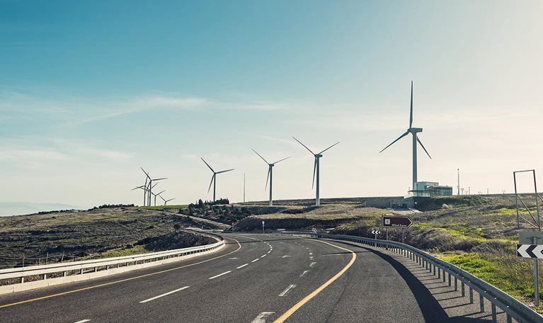 Asphalt highway with Wind turbines - stock photo