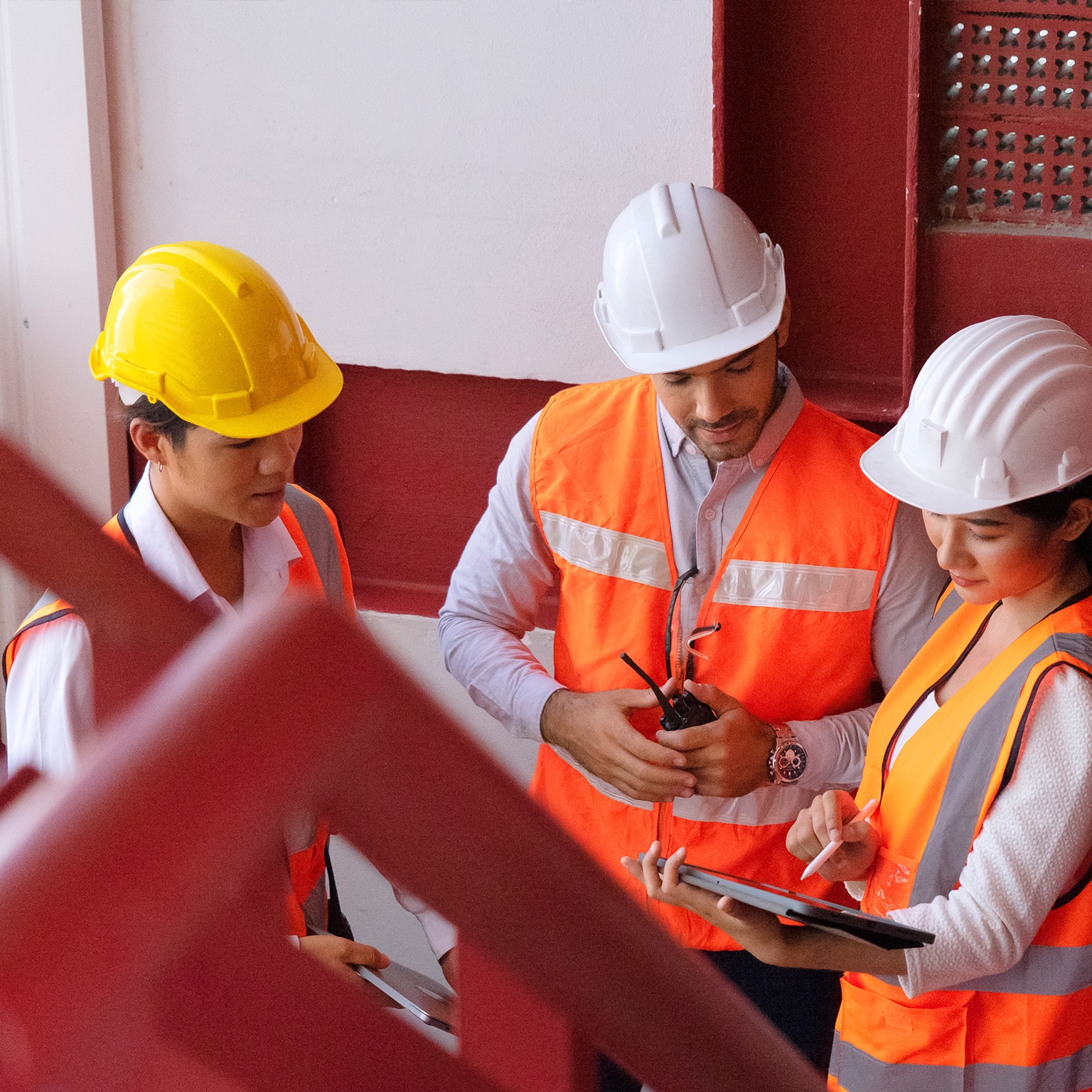 photo construction workers gathered around tablet