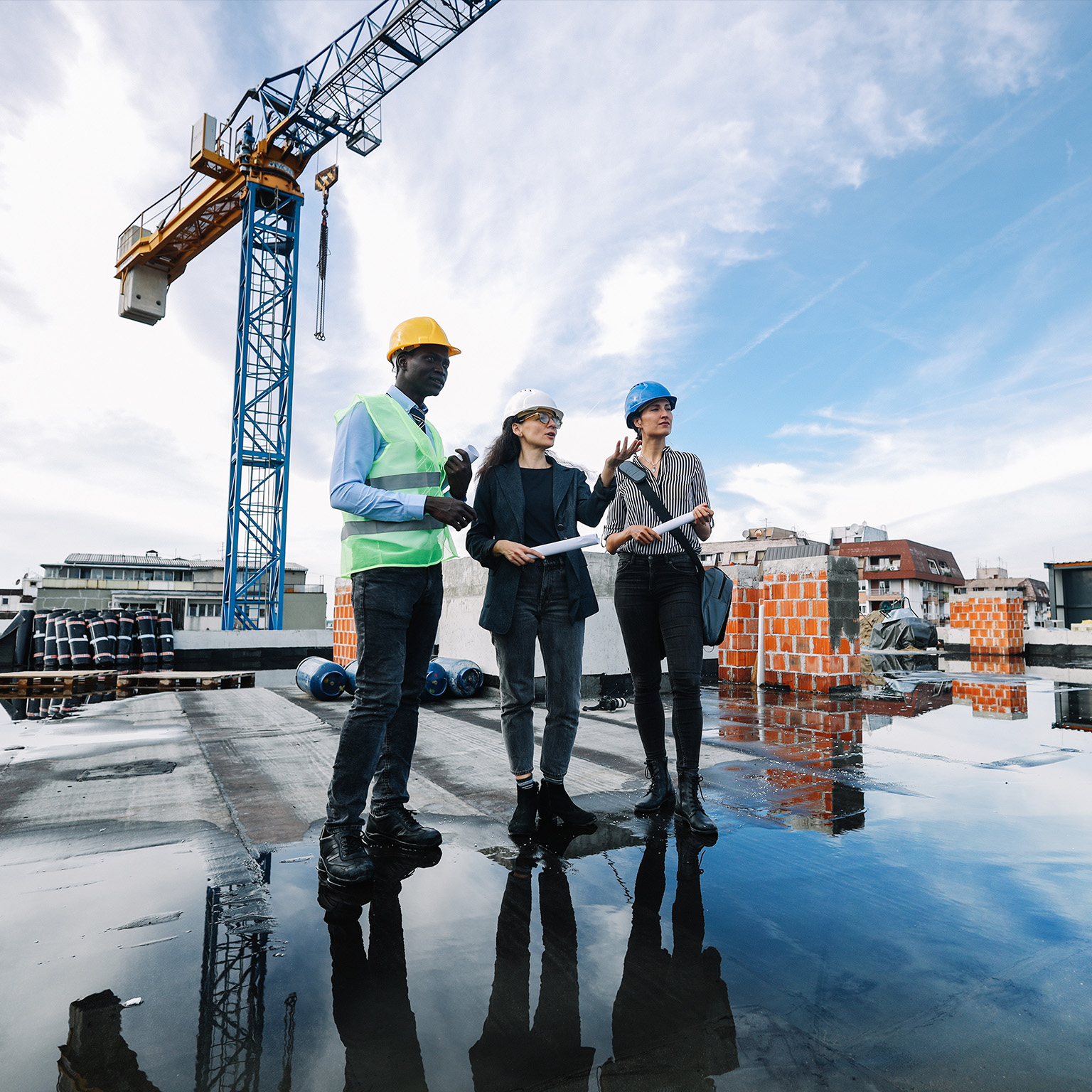 Architects and investors meeting at the construction site, on top of the residential building under construction. - stock photo