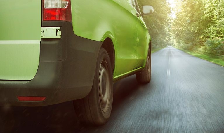 Sustainable freight transport vehicle driving down road