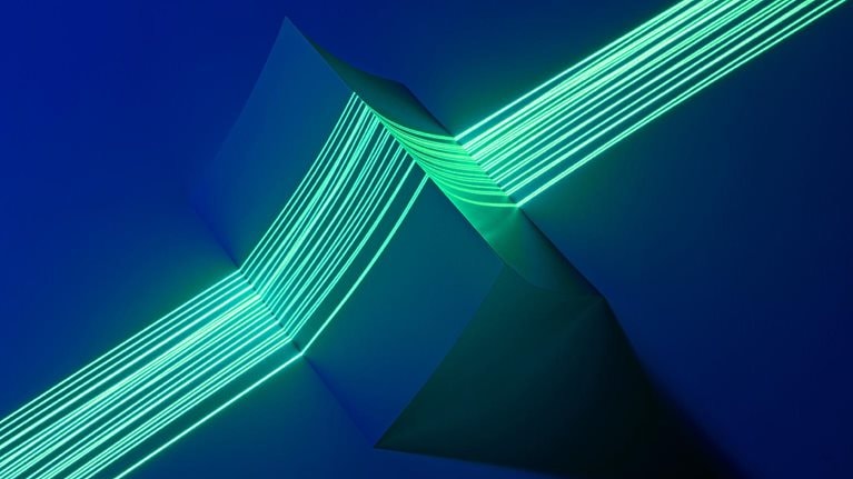 Image of multiple green laser lines coming together to precisely measure a triangle shaped object.