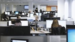 Image of office workers at their desks