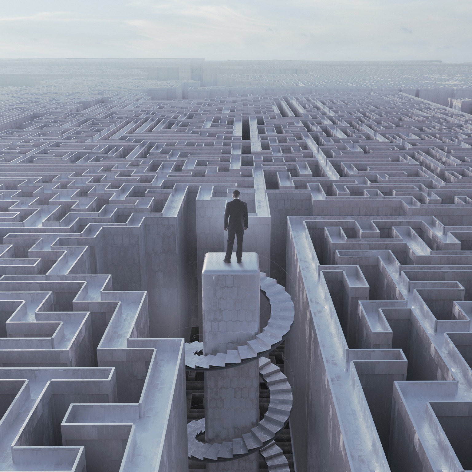 Businessman stranded at top of complex maze - stock photo