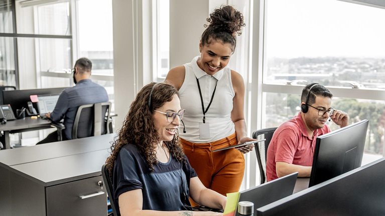 Call center manager instructing employees - stock photo