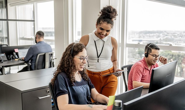 Call center manager instructing employees - stock photo