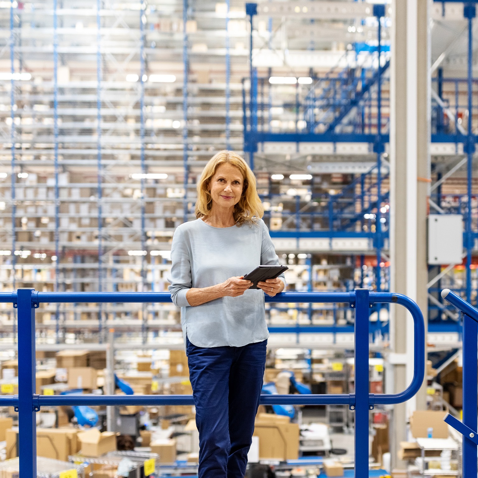 Portrait of a mature supervisor with digital tablet at warehouse - stock photo