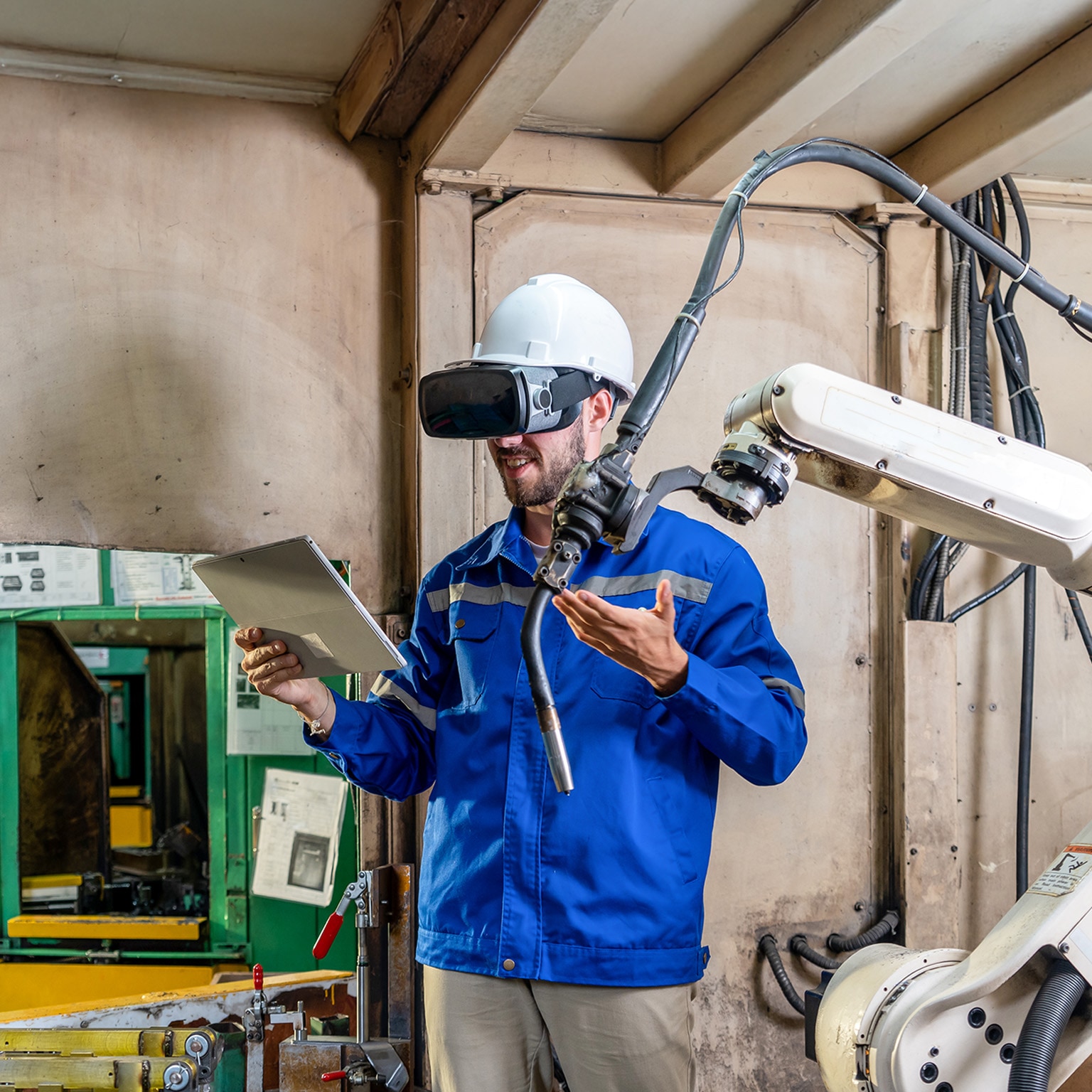 Engineer works with a HoloLens: place a virtual robotic arm into the production line