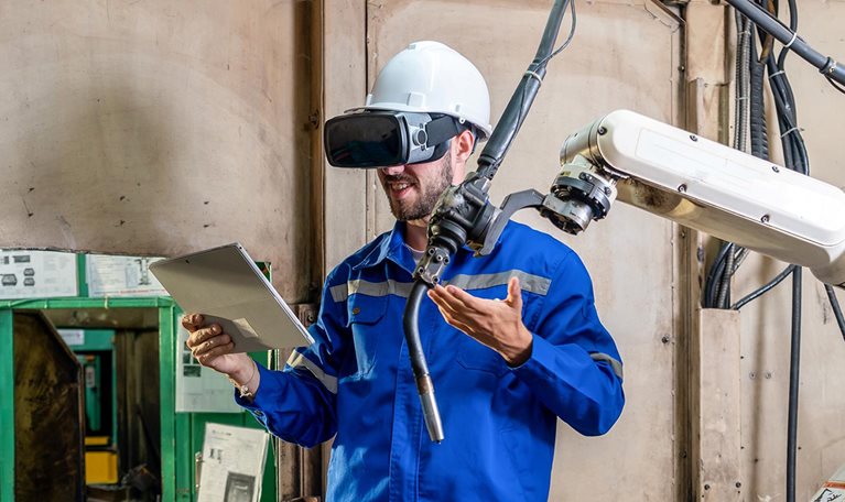 Engineer works with a HoloLens: place a virtual robotic arm into the production line
