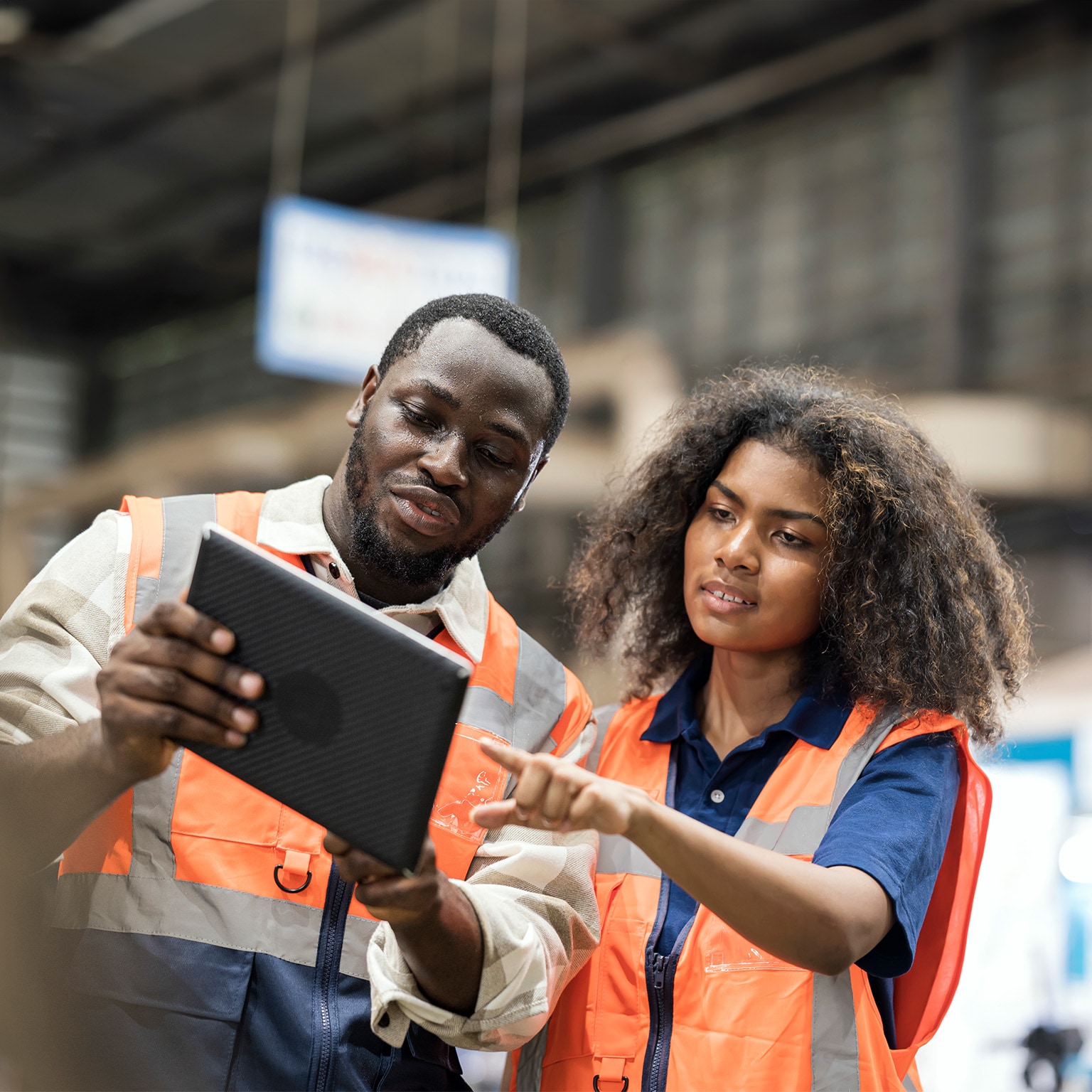 Production Control Engineers is having discussion on production daily report for resource planning related to production on tablet in factory shop floor. - stock photo