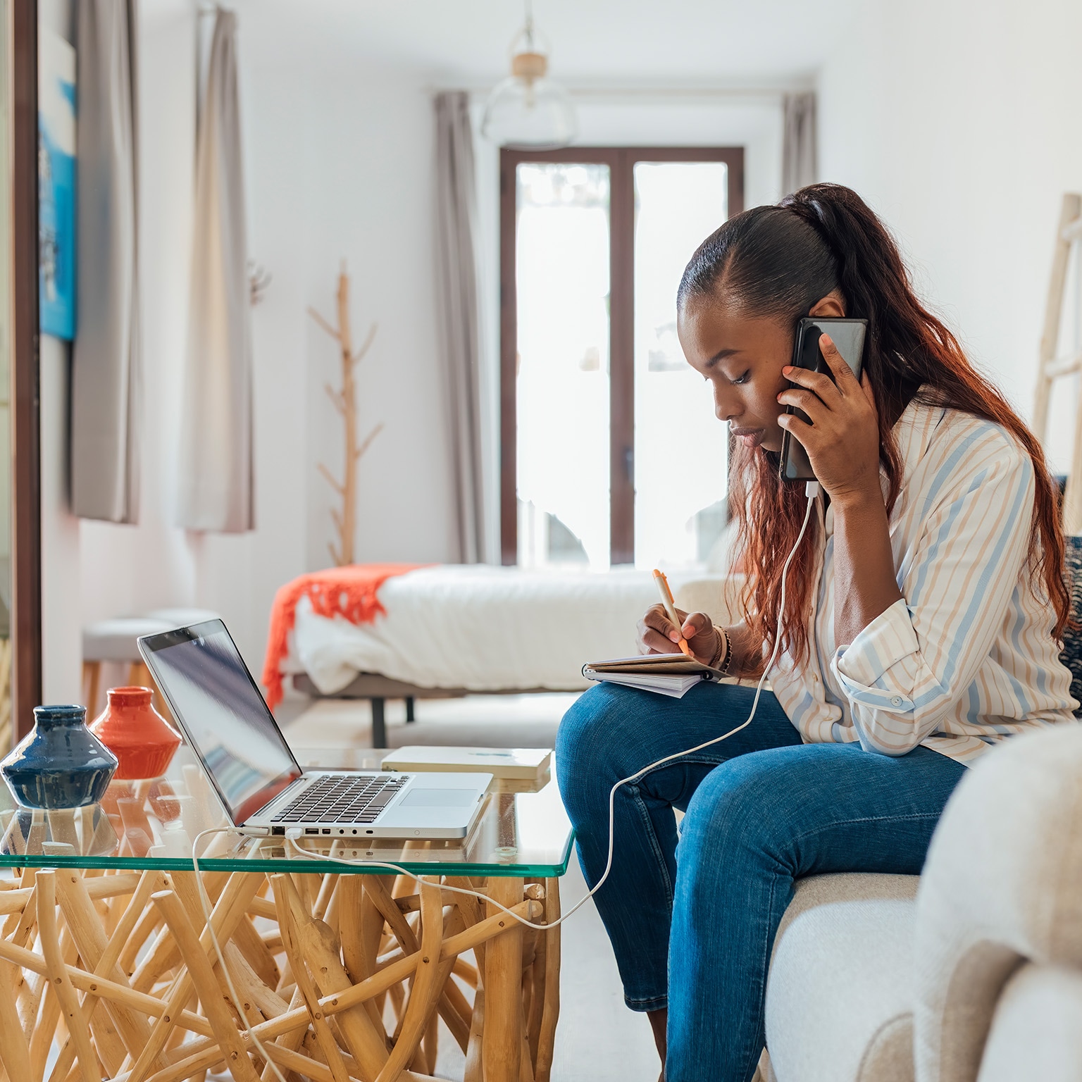 Customer on the phone and with laptop in front of them