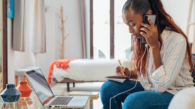 Customer on the phone and with laptop in front of them