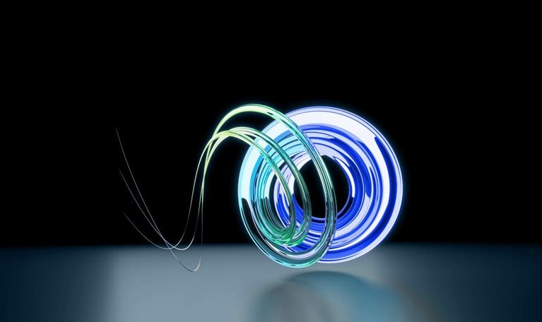 A circular arrangement of intertwining tubes made of luminous teal and blue glass, placed on a backdrop of deep blue.