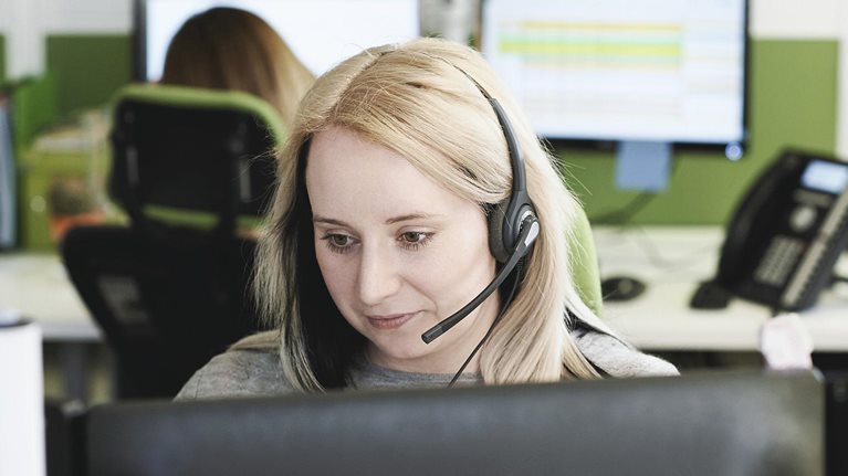 Young woman taking call in call center