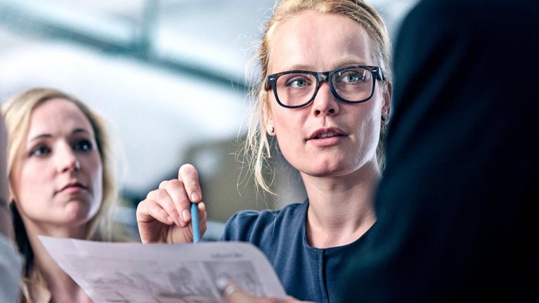 Women leading her team in business meeting