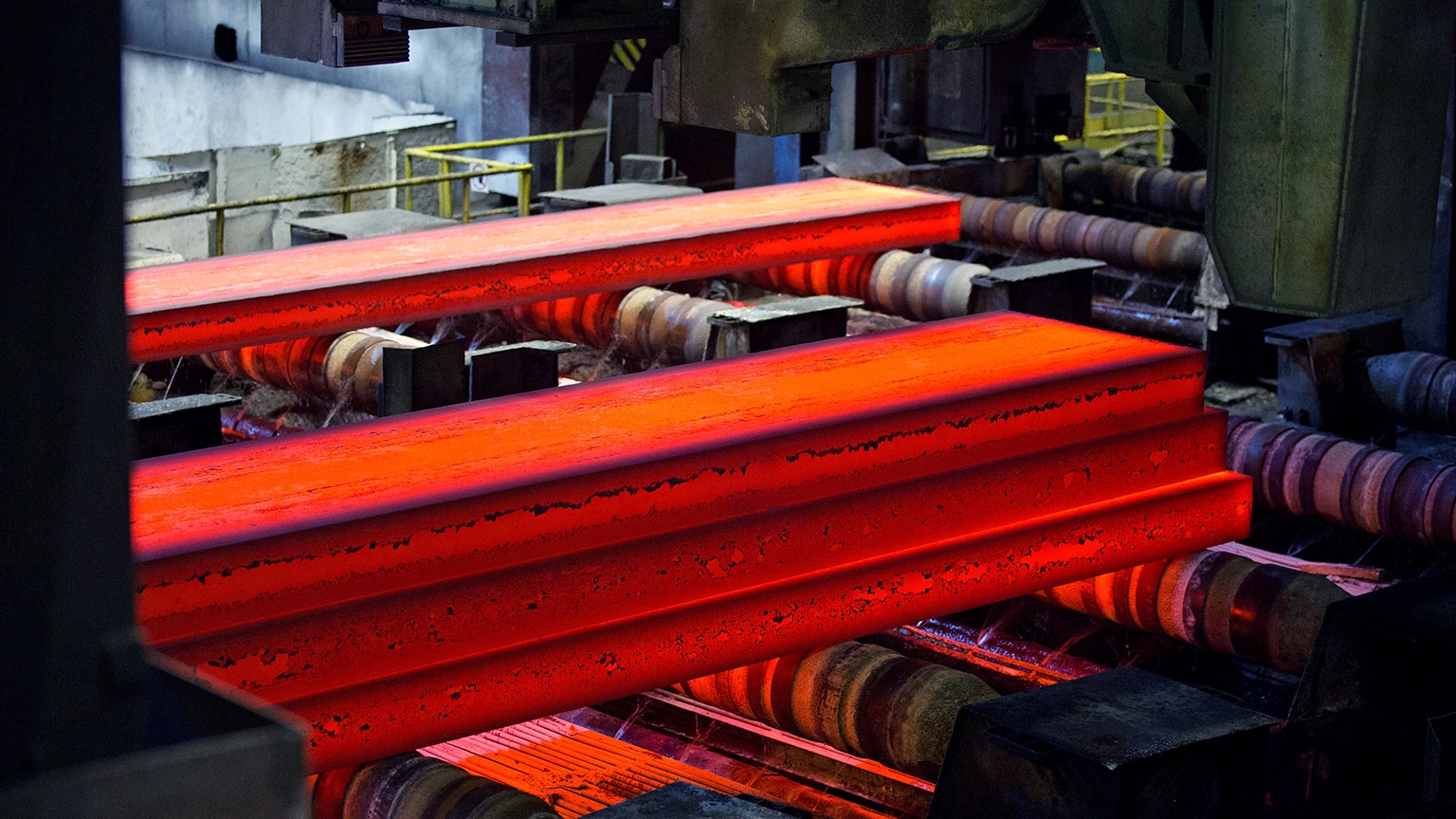 Image of red hot steel slabs emerging from the continuous casting machine.