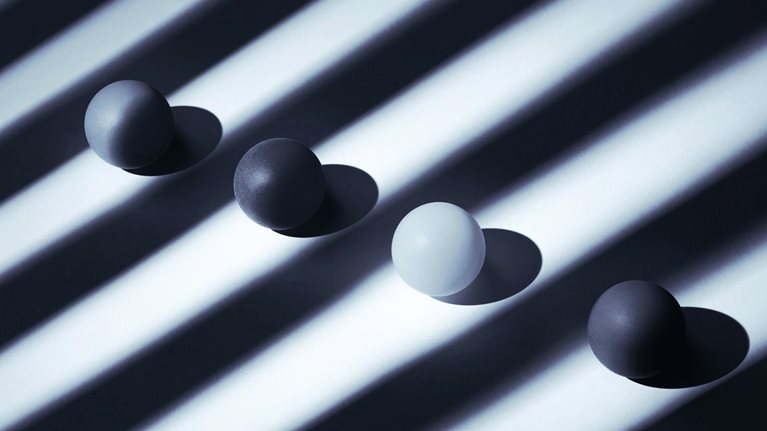 Photo of balls in a row on striped background