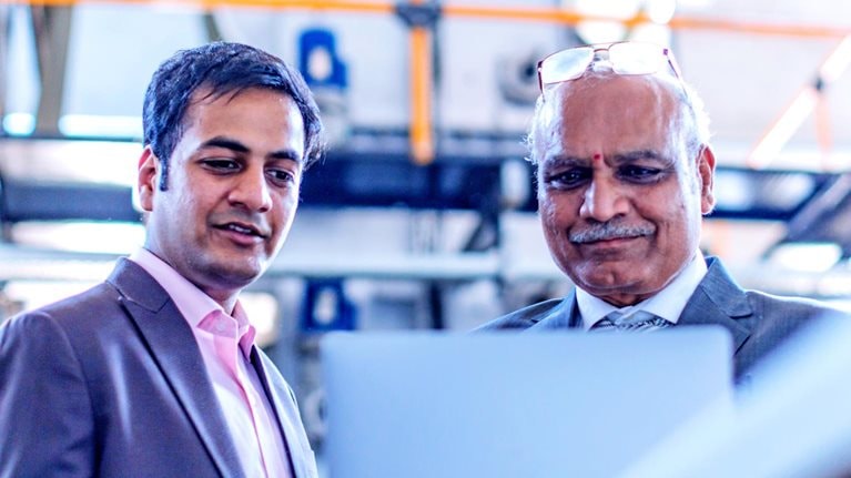 Two men looking at a laptop screen